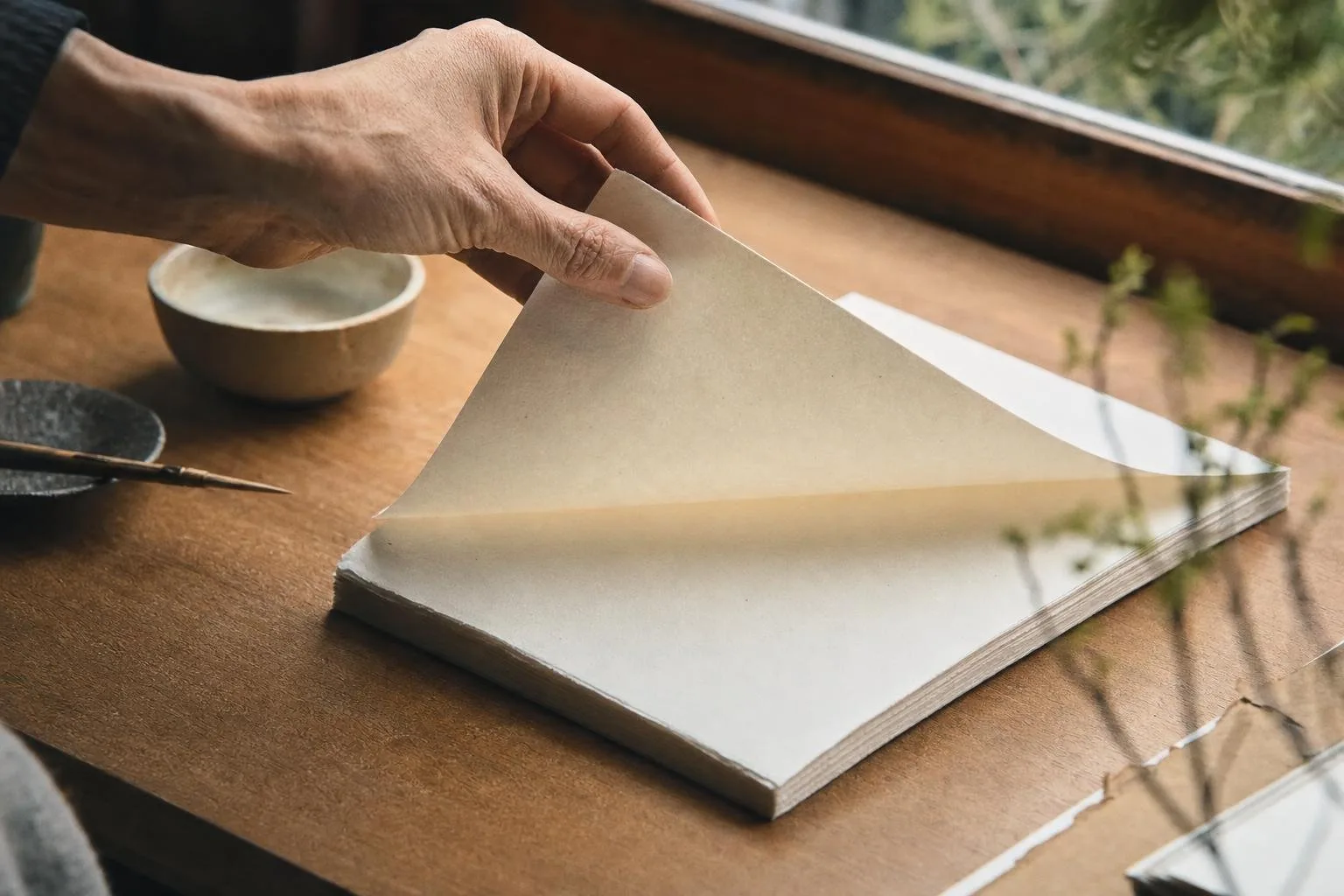 Writing desk with letterpress cards, a fountain pen, and wrapped gift sets